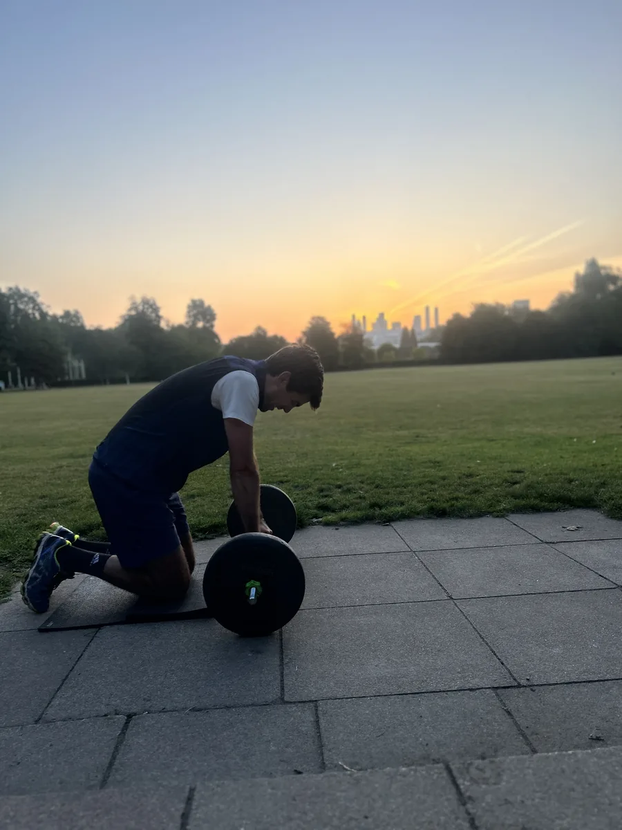 Client training alone at sunset in Battersea Park