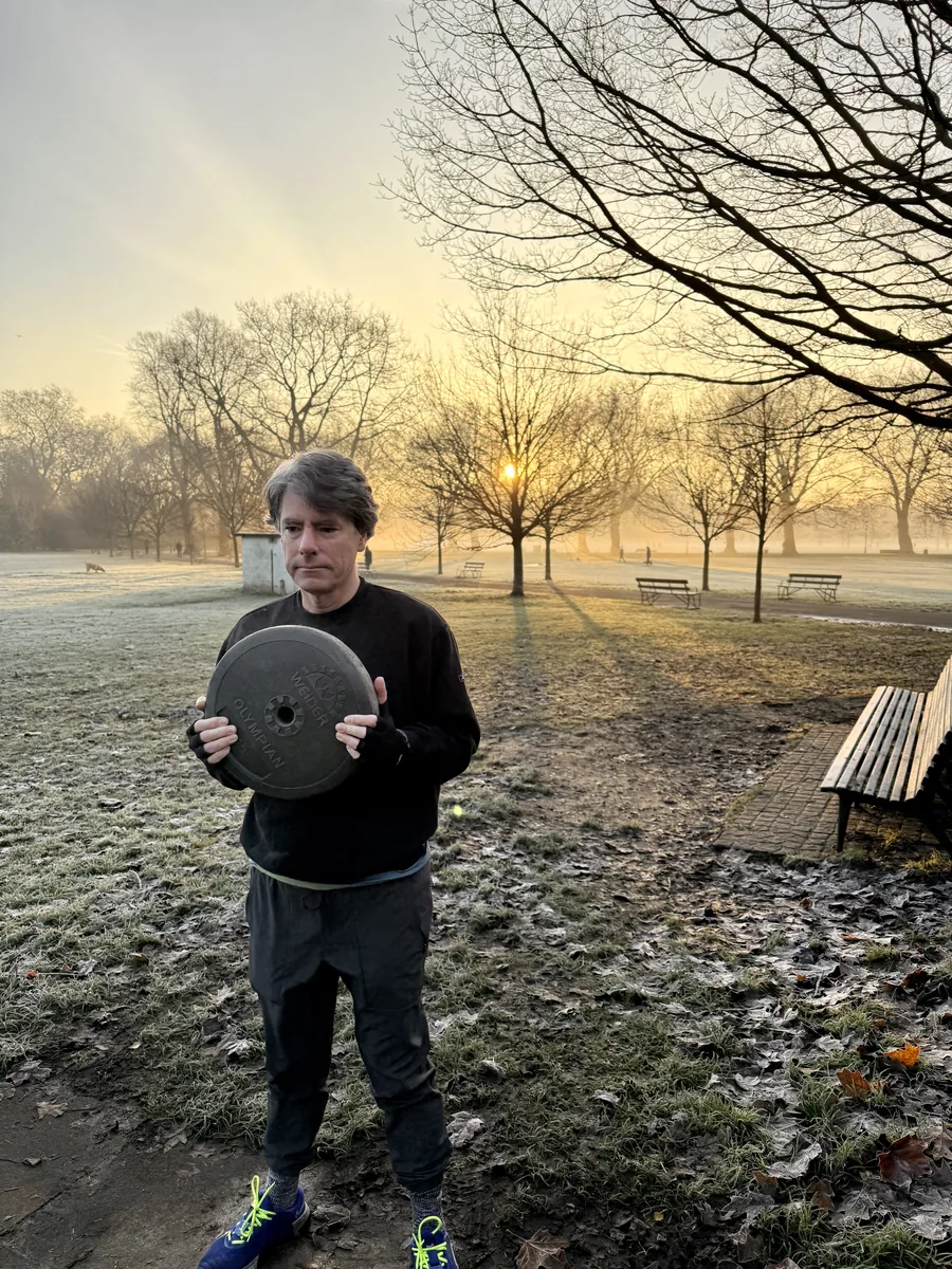 Client training with weights on a frosty winter morning in Battersea Park